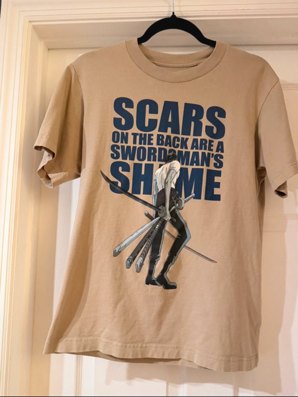 Uniqlo Tan Short Sleeve Tee with Blue Graphic Swords Print